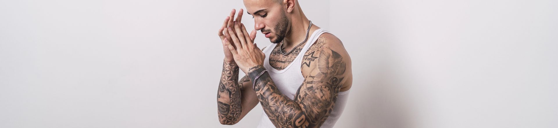 A portrait of a cool sexy tattooed Spanish male posing