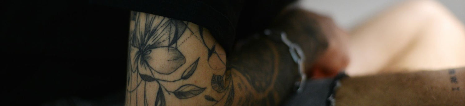 man with a temporary flower tattoo sleeve
