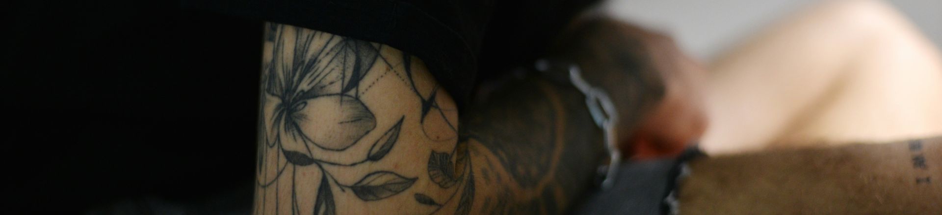 man with a temporary flower tattoo sleeve