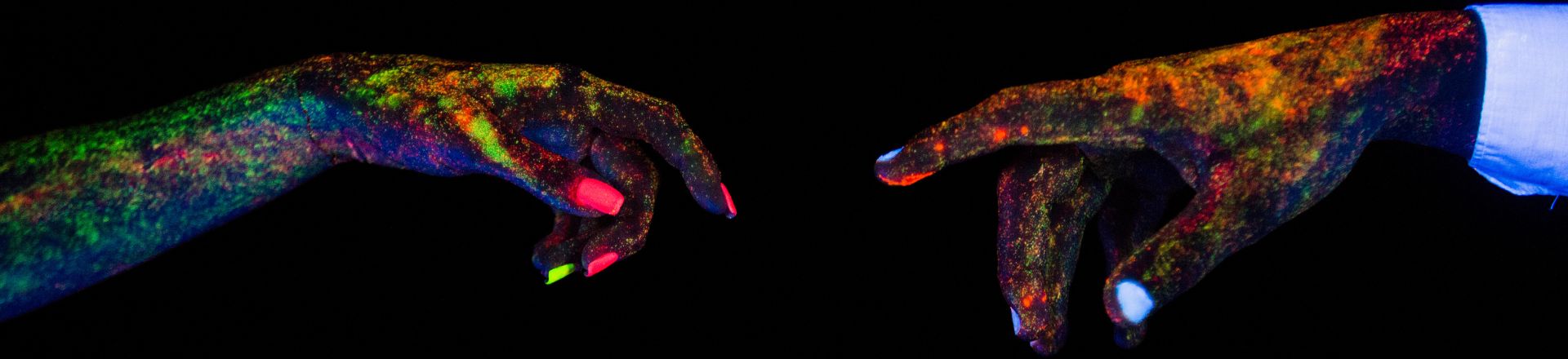 A temporary glowing tattoo on a man and woman's hands