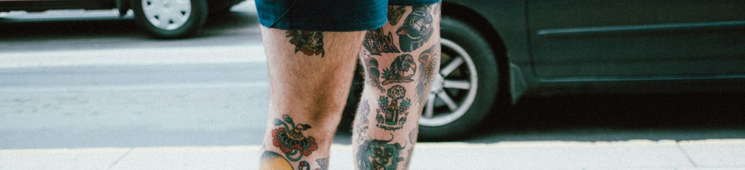 a man wearing temporay tattoo on his legs