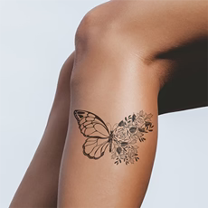 black butterfly tattoo on leg