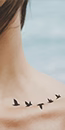 bird tattoo on collarbone