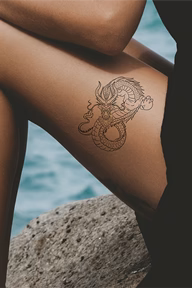 black dragon tattoo on thigh