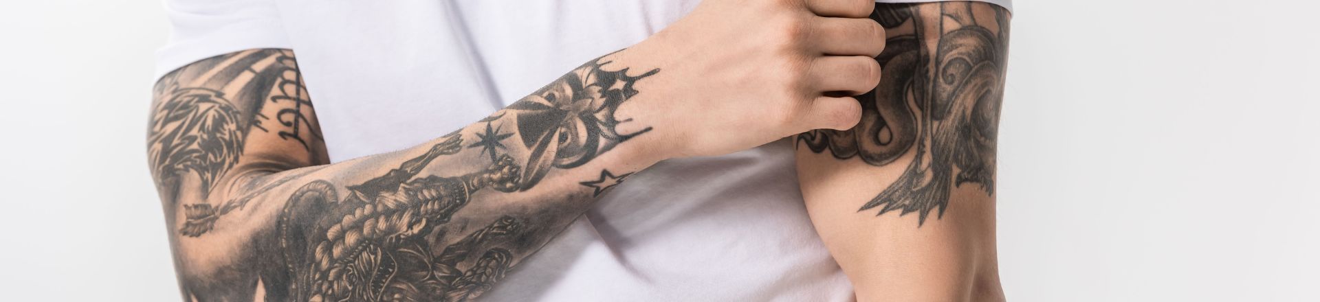 a man's arm full of non-permanent tattoo