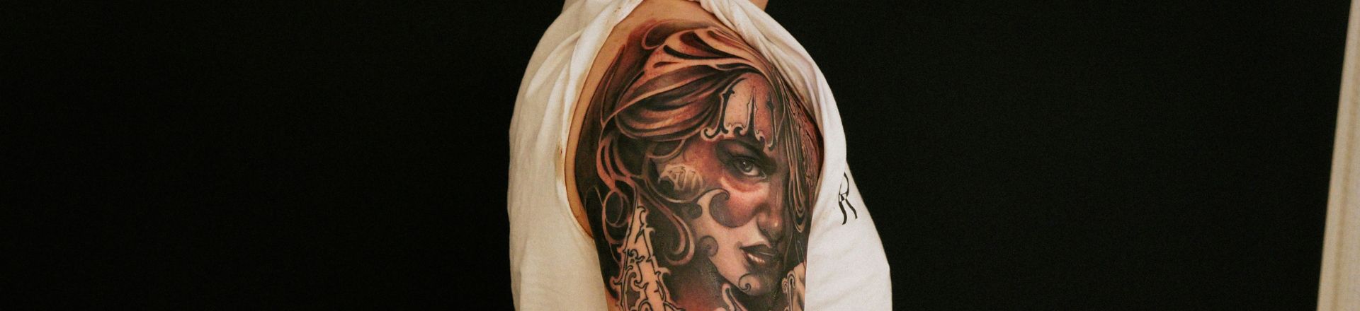 a man with full sleeve holiday tattoo