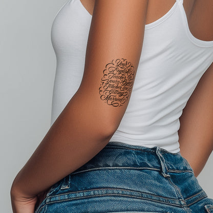 Person wearing a white tank top and blue jeans with a tattoo on their arm.