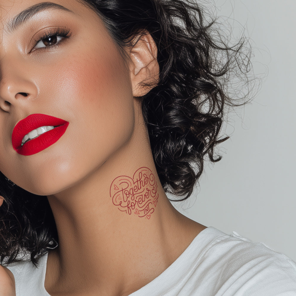 Woman with red lipstick and a tattoo on her neck against a neutral background