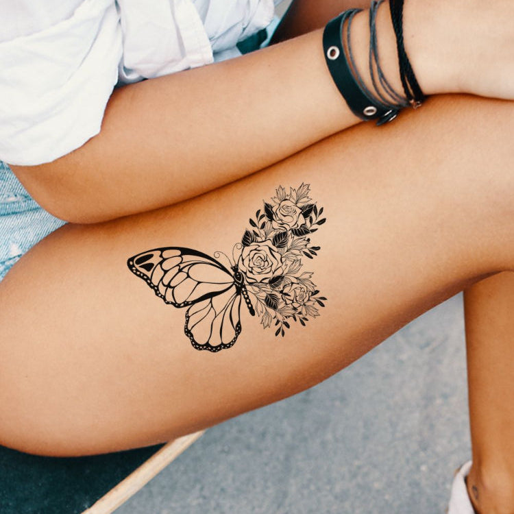 A woman with a butterfly tattoo on her thigh.