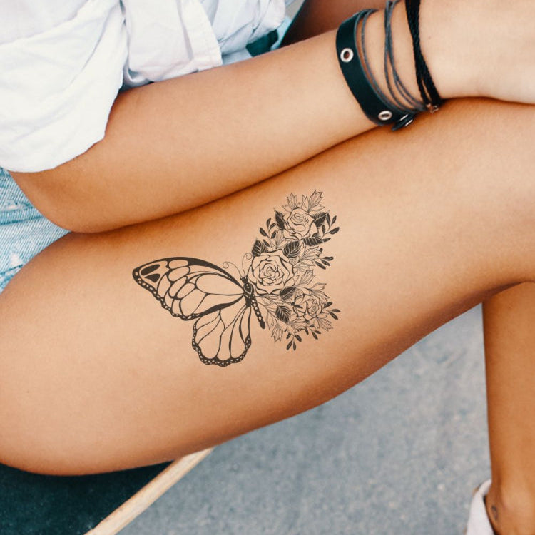A woman with a butterfly tattoo on her thigh.
