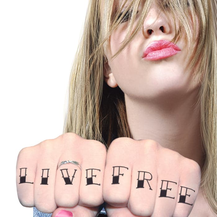 Tattooed man giving the finger, close-up stock photo