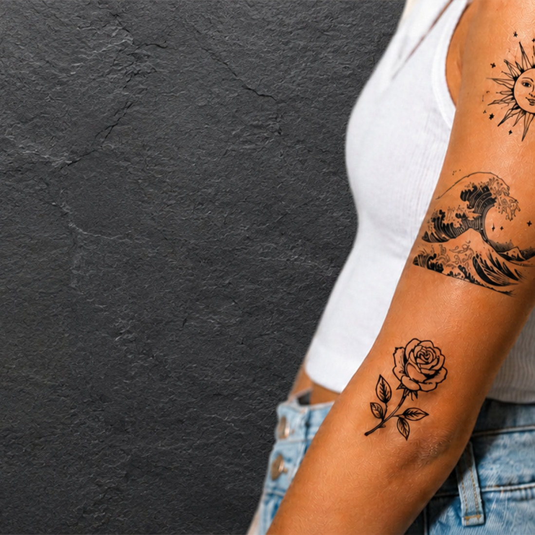 Person with temporary tattoos on their arm against a dark background