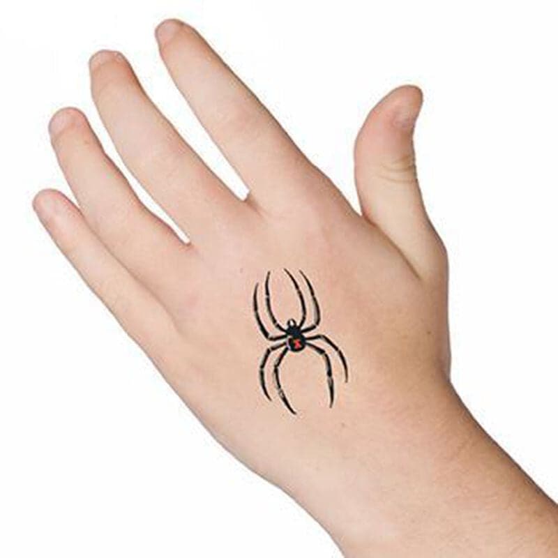 small black widow tattoo on back of hand